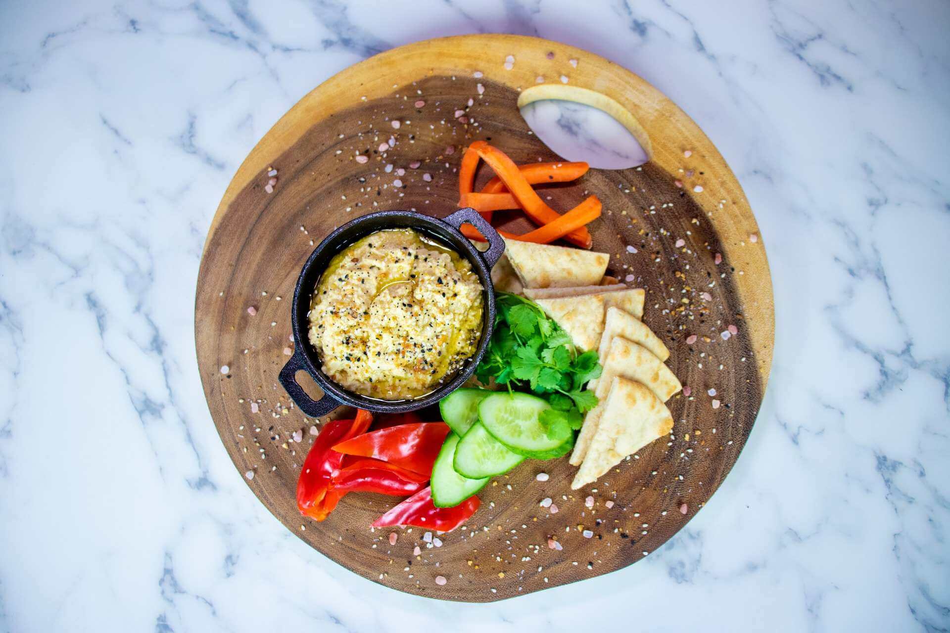 Plate-with-hummus-cucumber-and-slices-of-pita-bread