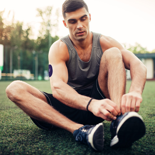 A man tying his shoe.