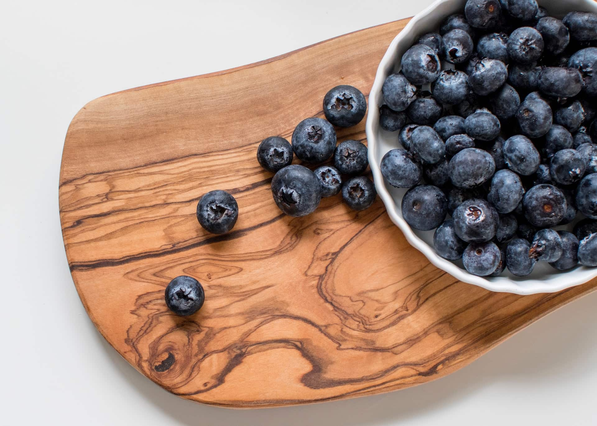 Blueberries-on-wooden-chopping-board