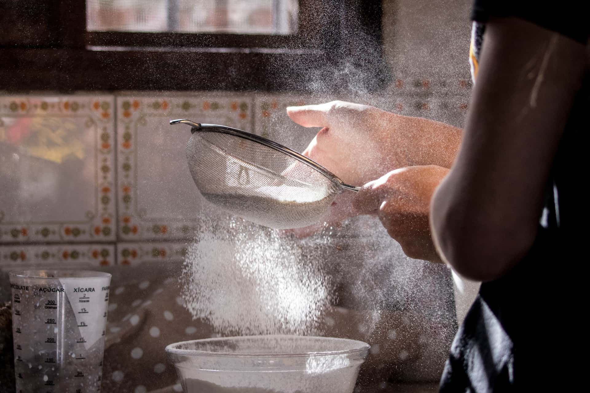 A-person-off-camera-sifting-flour-healthy-flour