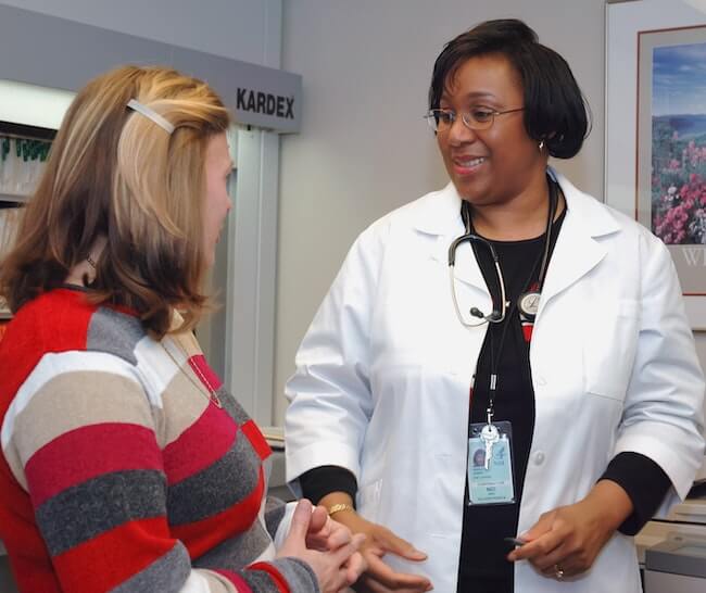 Woman doctor discussing care plan with patient during office visit