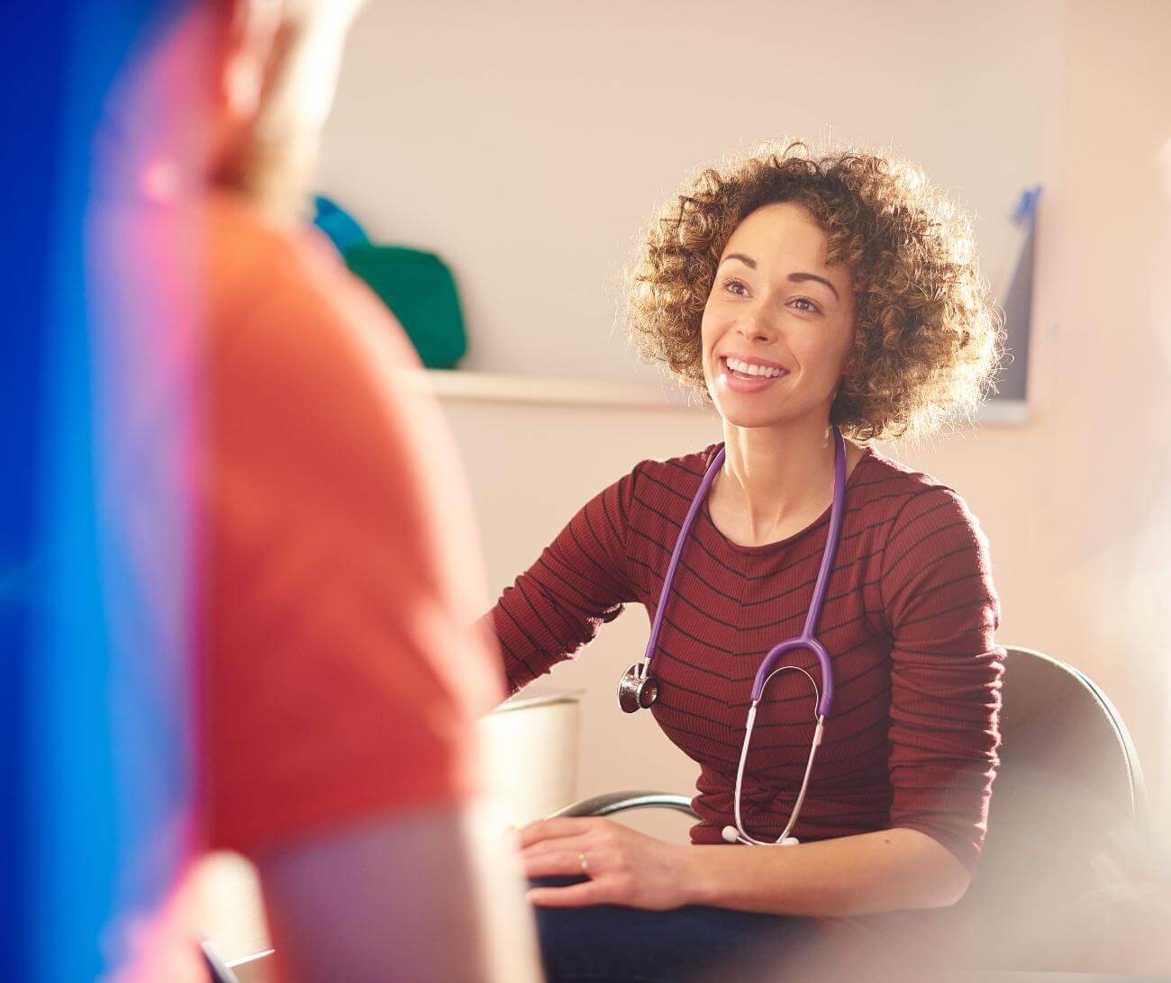 Female doctor smiling while talking to patient