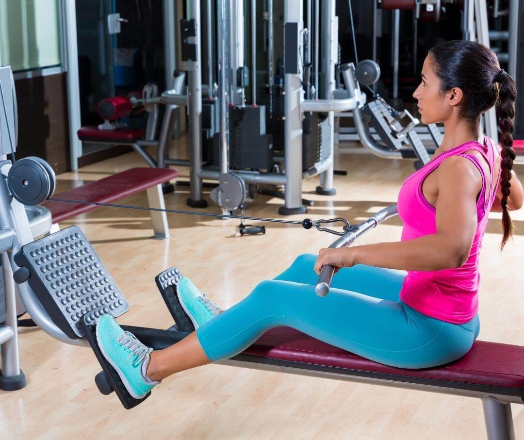 Woman using rowing machine at the gym