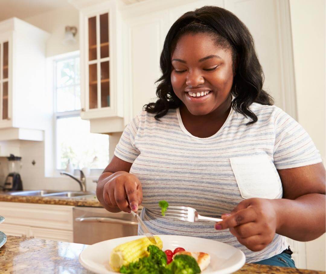 woman eating a healthy meal in the kitchen