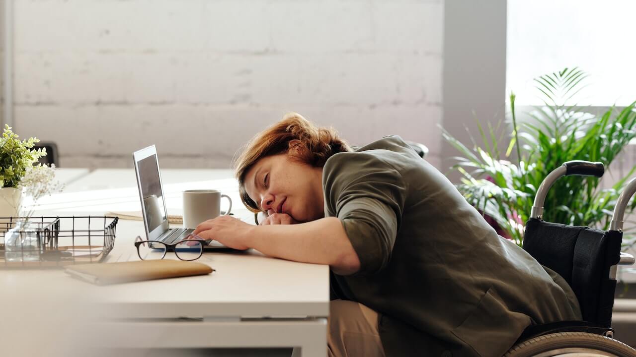 Woman-sleeping-on-top-of-laptop-middle-of-the-day