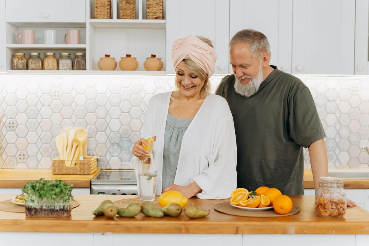 elderly-man-and-woman-cooking-healthy-meal-together