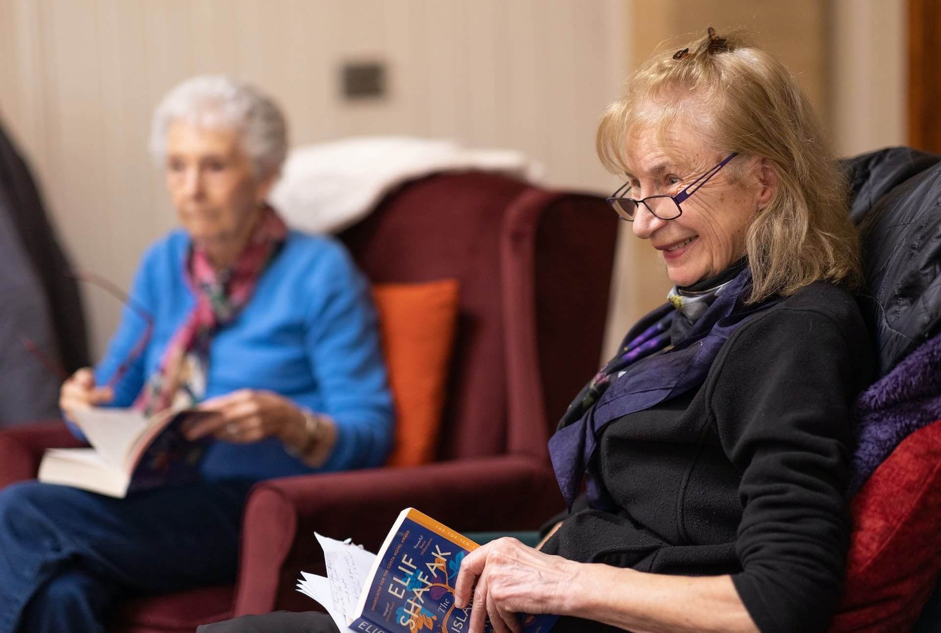 Older-woman-reading-a-book-with-friends-best-vitamins-for-women-over-50