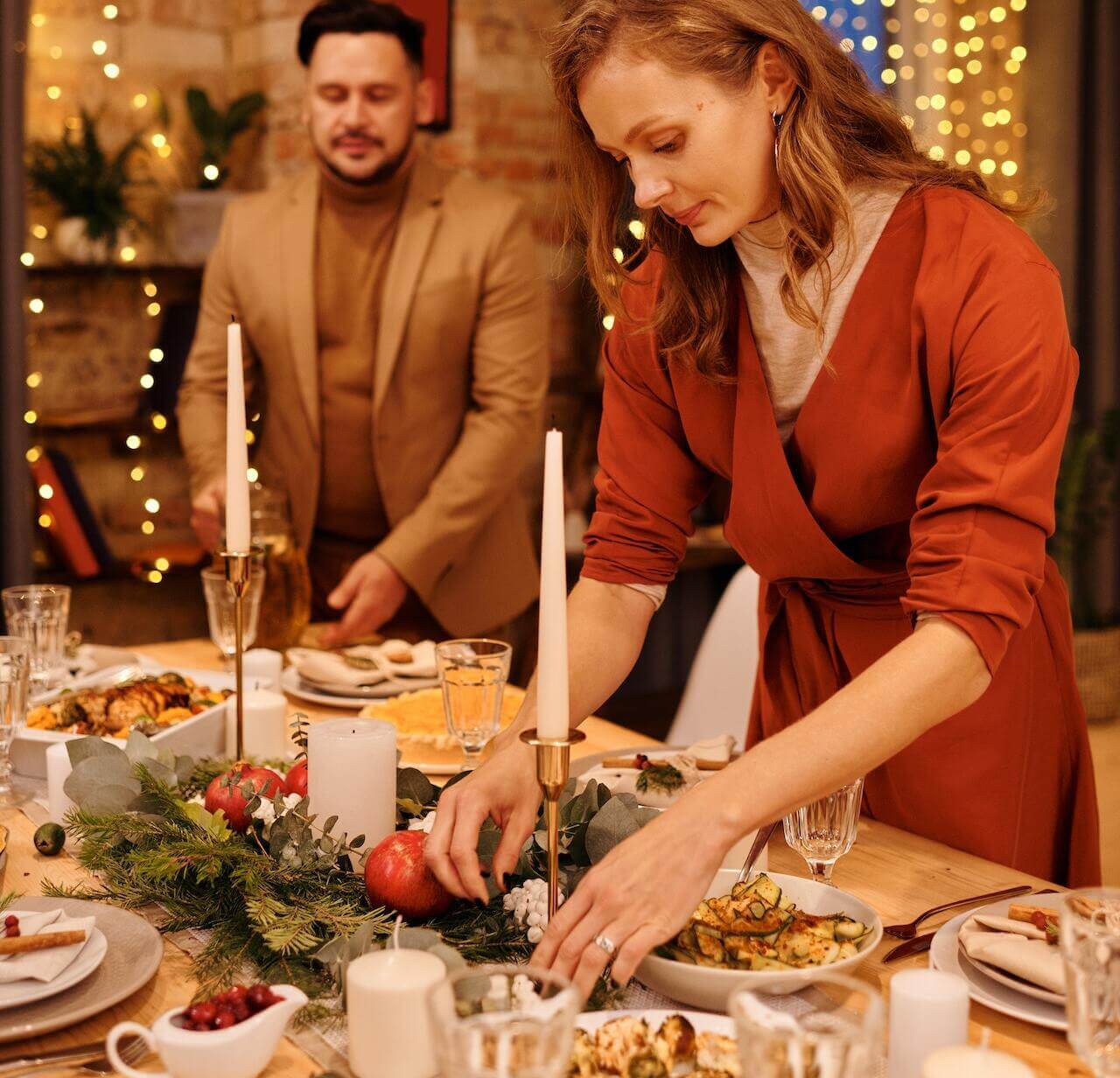 Woman-Setting-a-Christmas-Dinner-on-dining-room