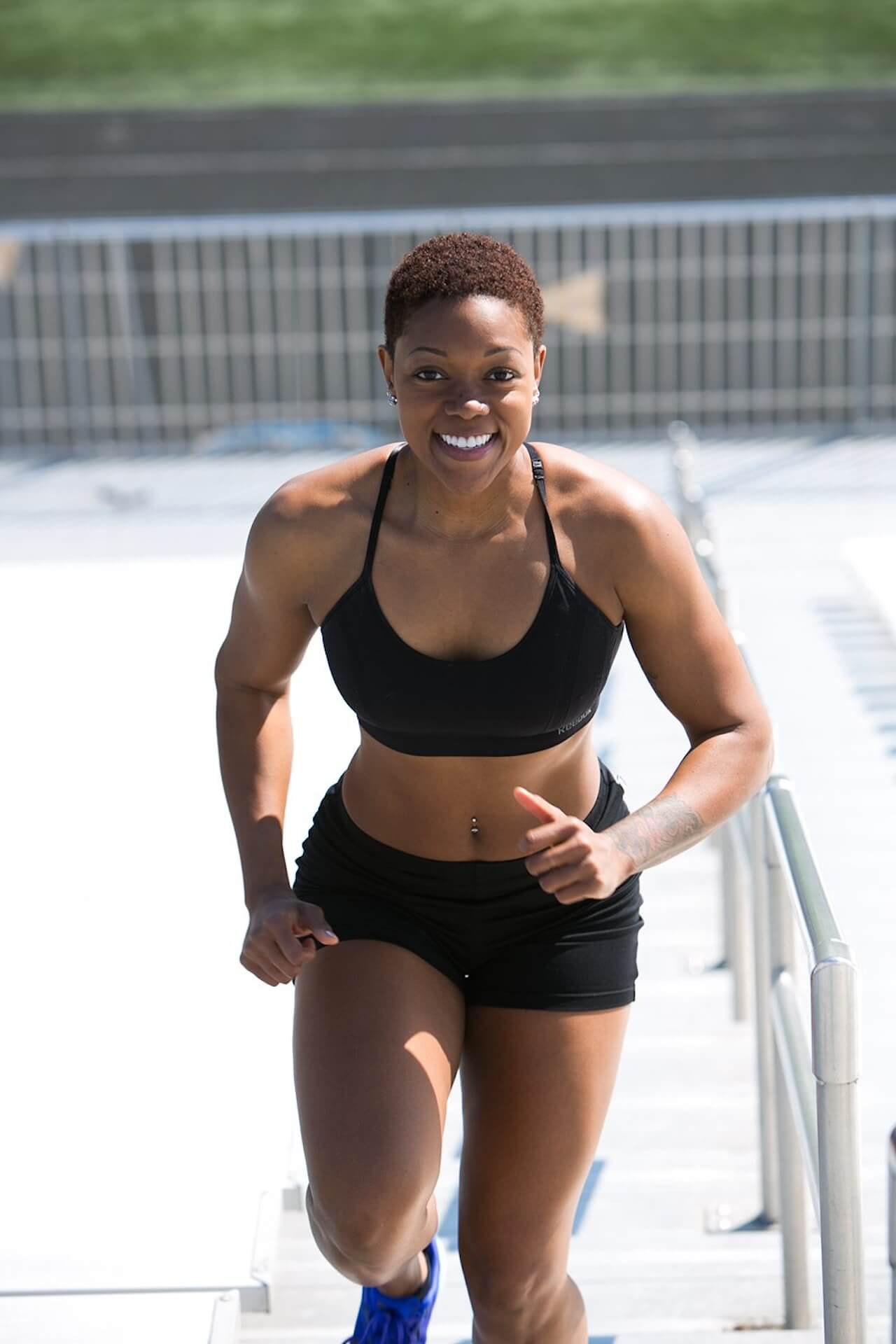 Woman-Wearing-Black-Sports-Bra-and-Jogger-Shorts-Smiling