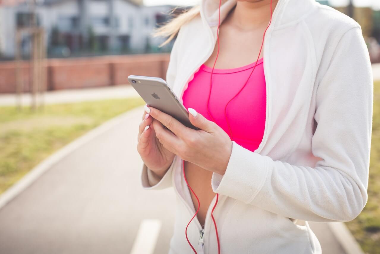 Woman-in-White-Jacket-Holding-Silver-Iphone