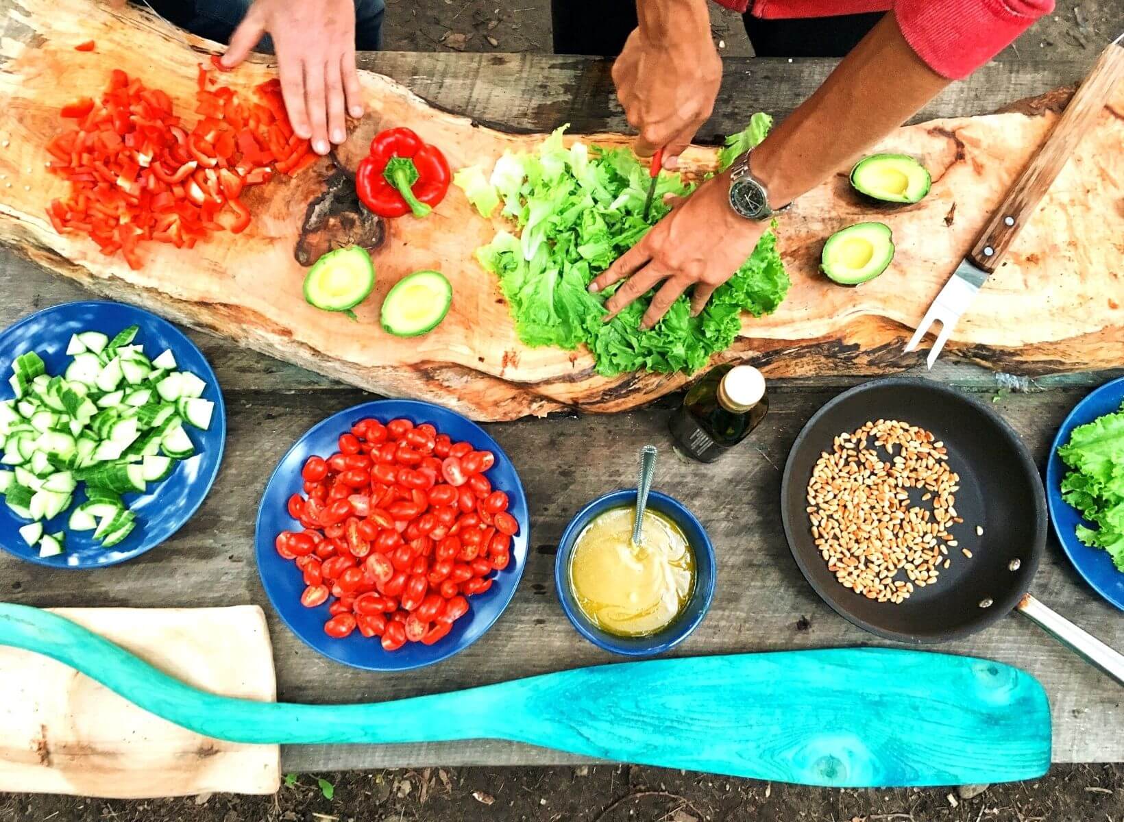 An overhead shot of salad preparation, a meal that is unlikely to spike your blood sugar that may help you lose weight