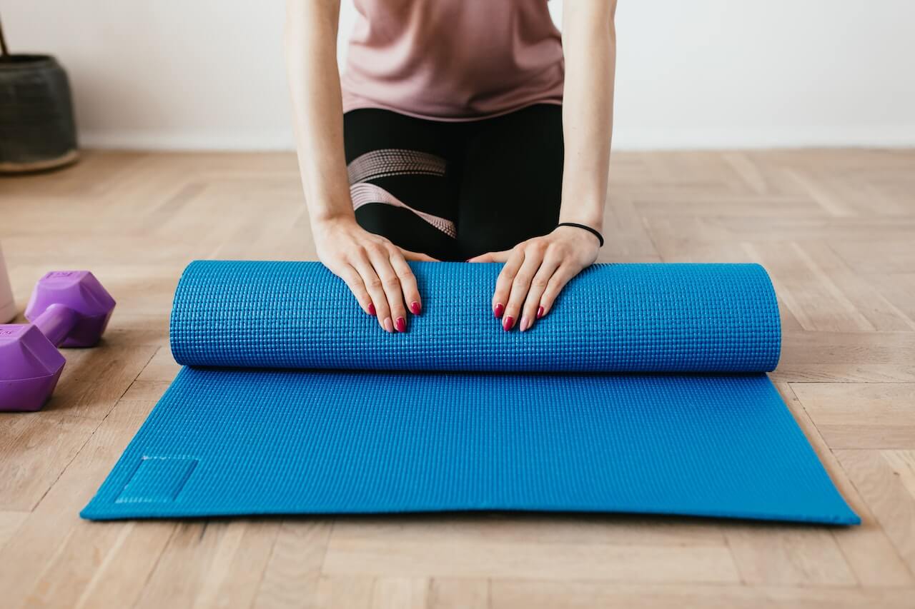 sports-mat-being-folded-on-wooden-floor