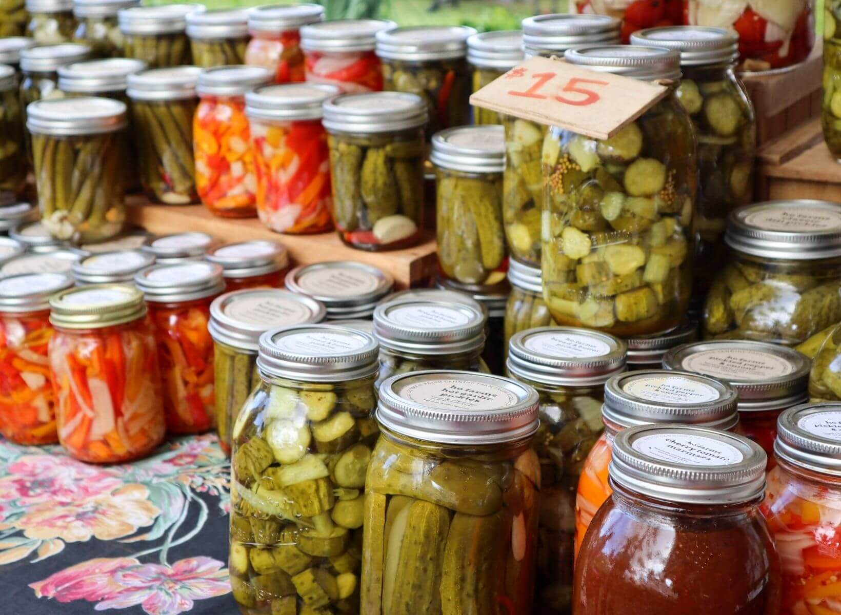 Numerous mason jars with probiotic-rich fermented foods, including pickles and vegetables.