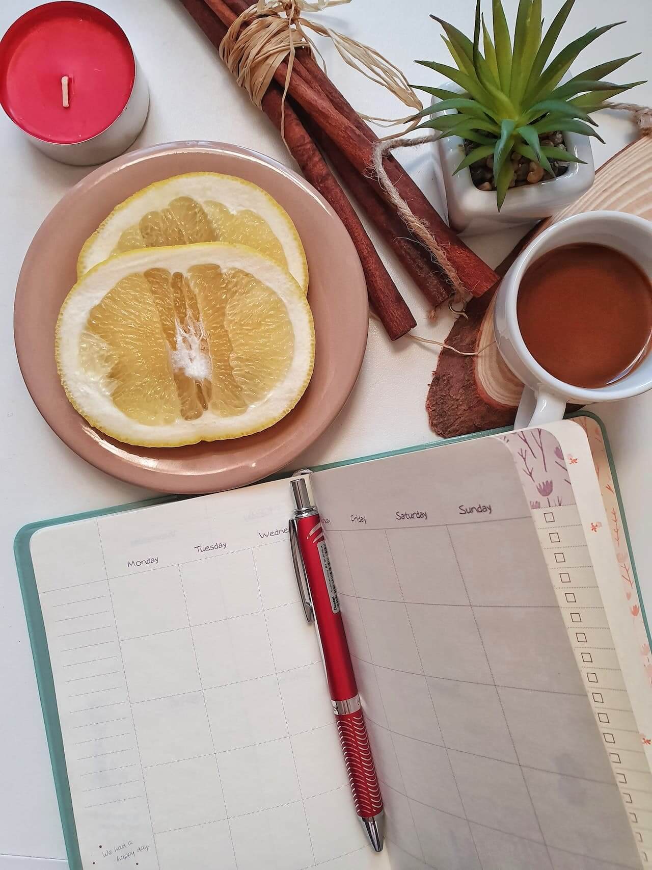 planner-slices-of-orange-and-a-coffee-on-a-table