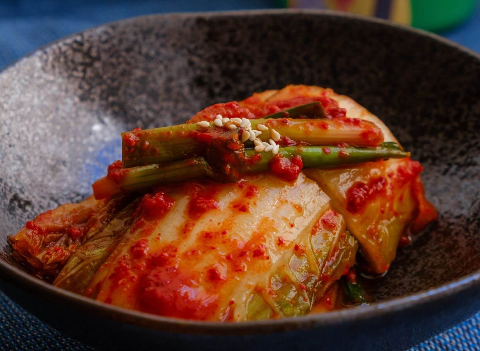 A close up shot of a bowl of kimchi, fermented vegetables that are high in probiotics, which contribute to gut health