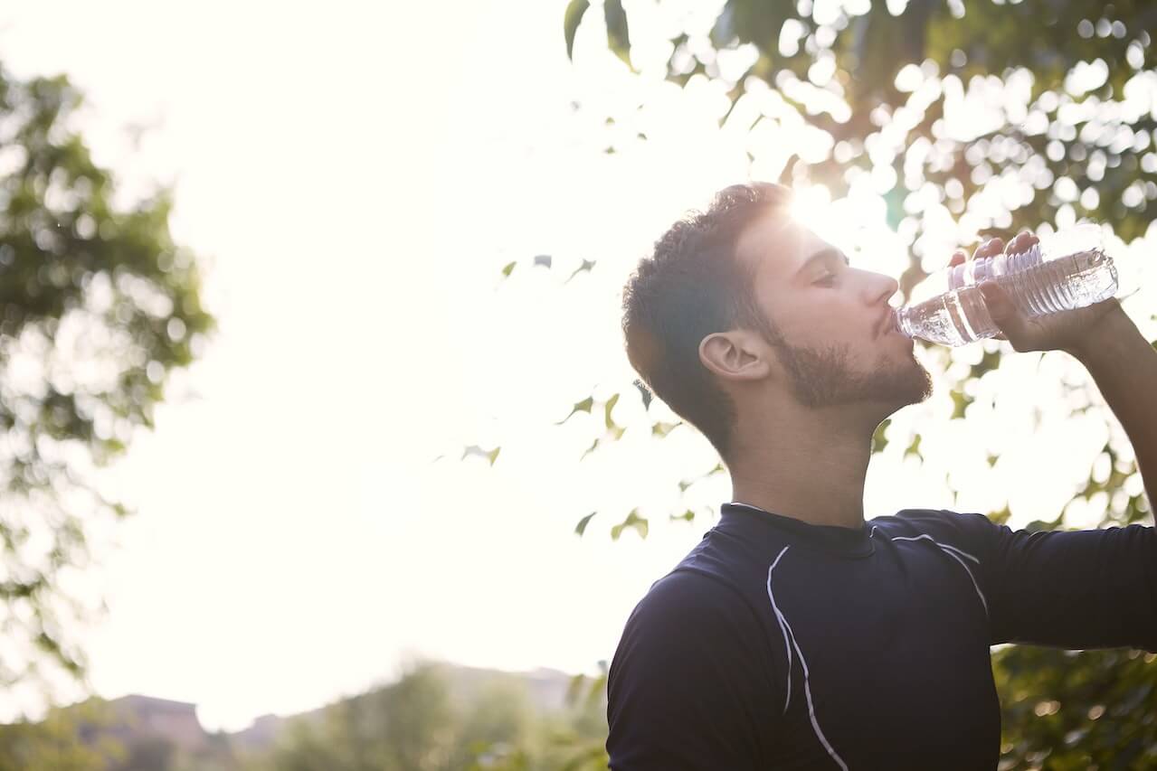 Man-in-black-crew-neck-shirt-drinking-water