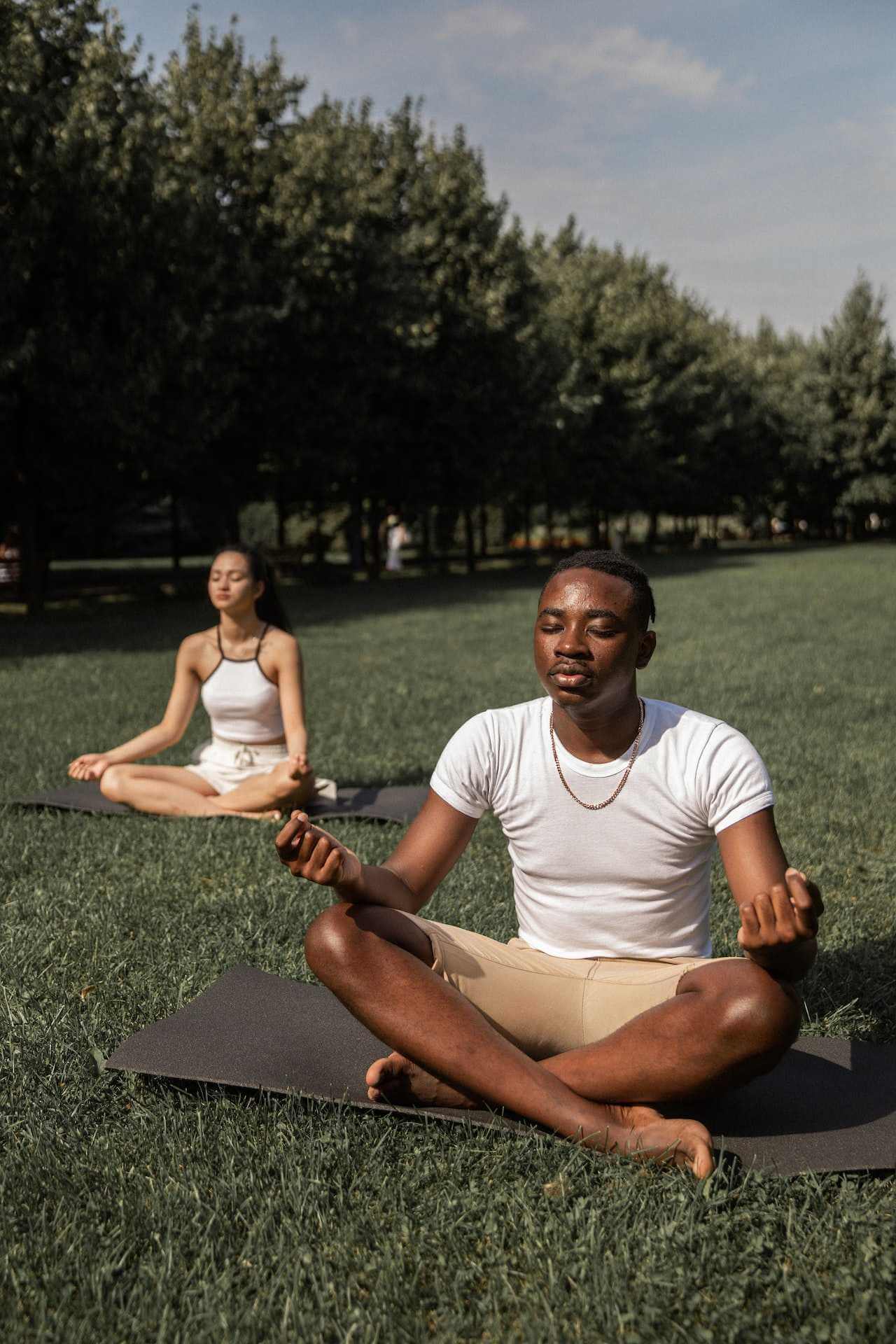 multiracial-friends-doing-yoga-outdoors