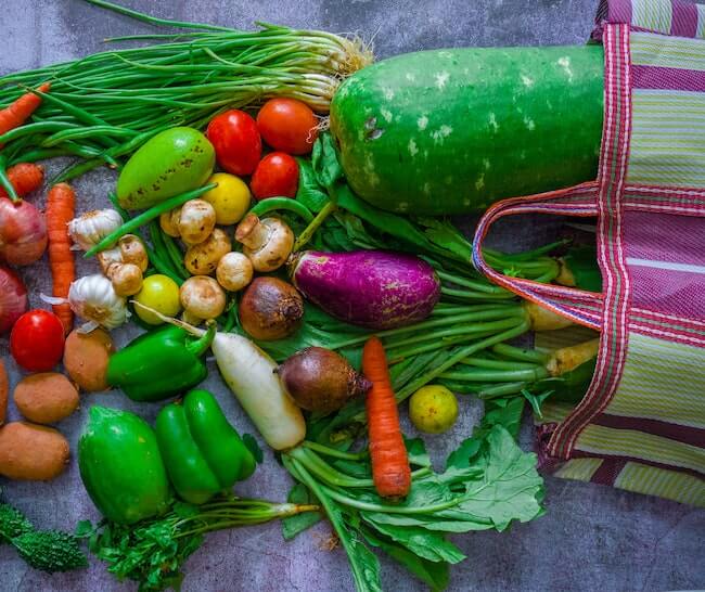 A colorful medley of produce spilling out of a bag onto a table