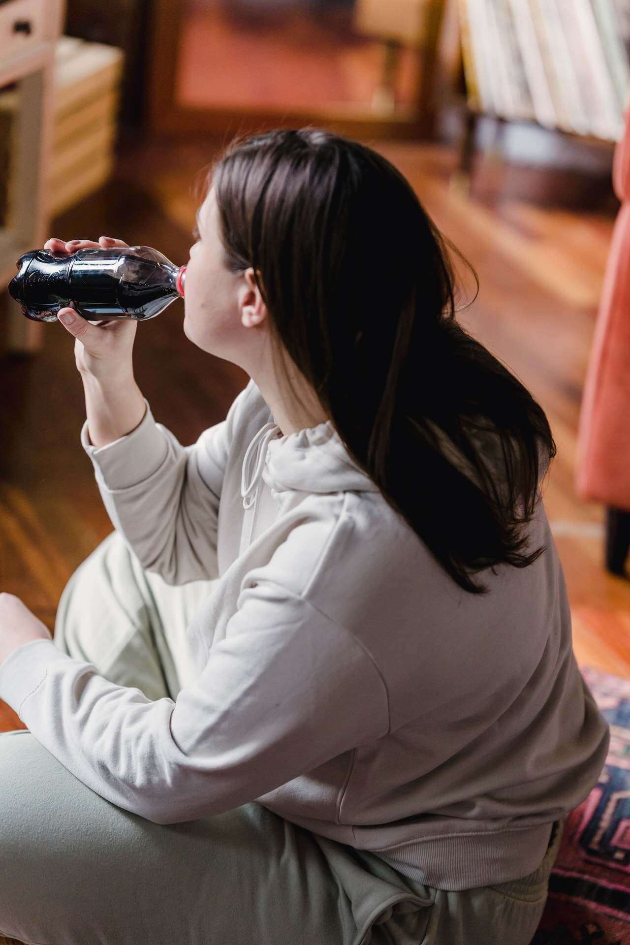 woman-drinking-soda-in-her-room