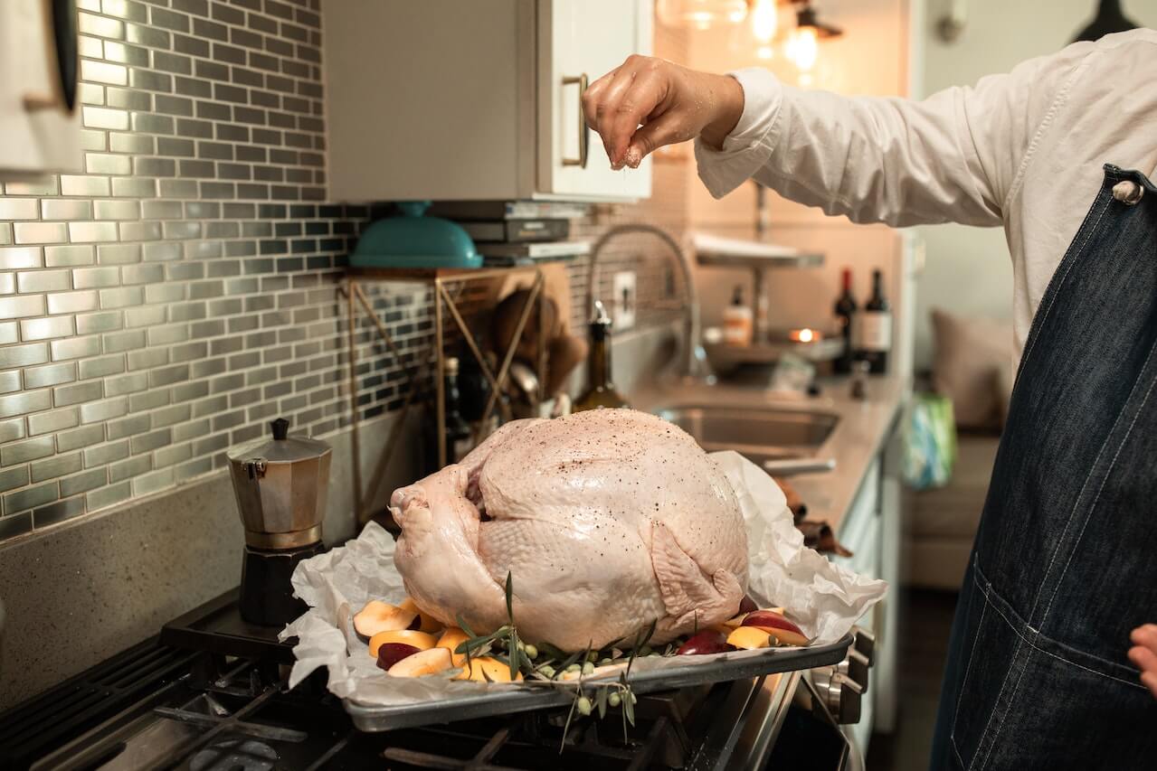 chef cooking turkey in kitchen