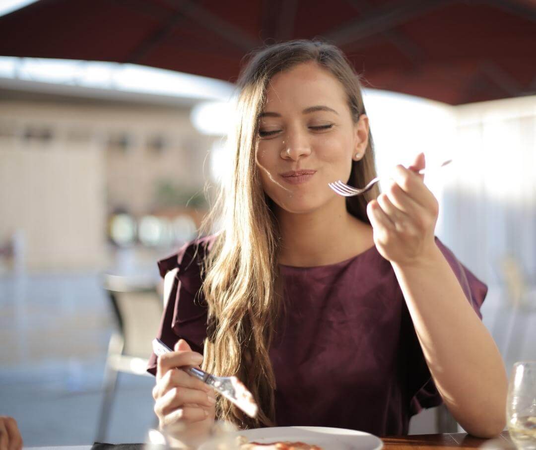 woman enjoying lunch at an outdoor cafe