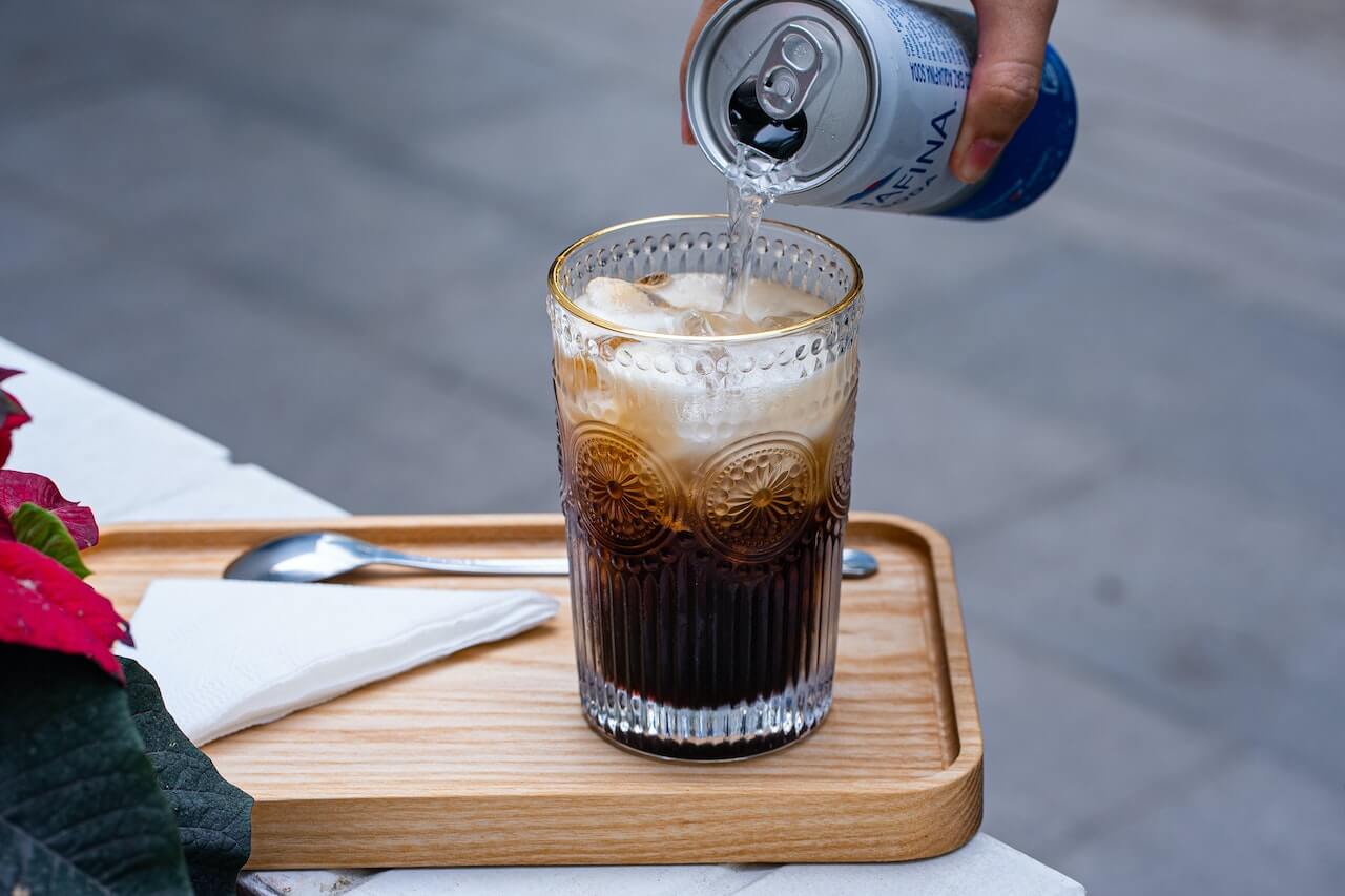 pouring-soda-on-glass-outdoors