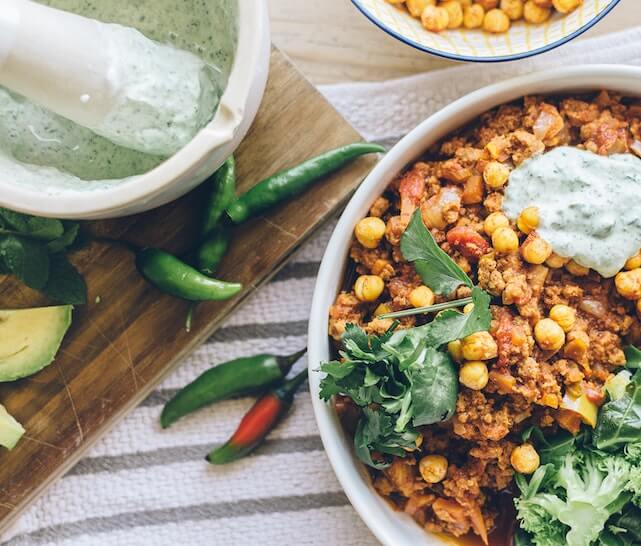 An example of a low-sugar meal; a bowl of chick peas, broccoli, avocado, and ground chicken.