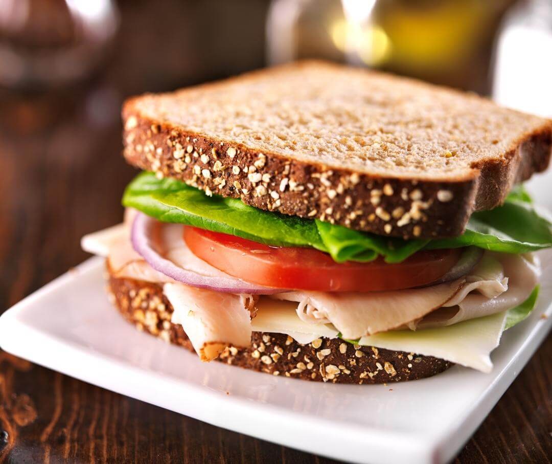 turkey sandwich on a white plate