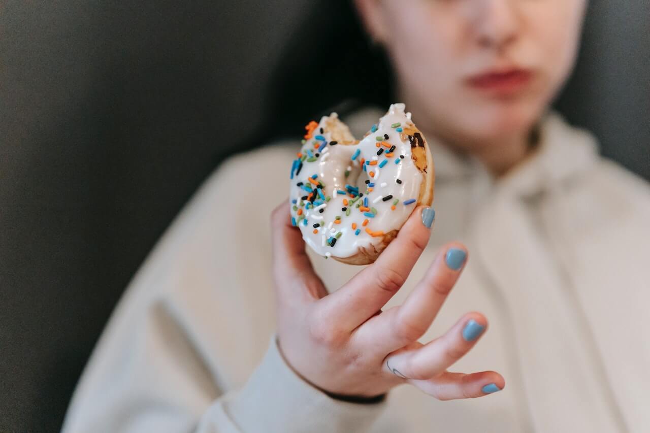 woman-holding-donut-after-biting-it