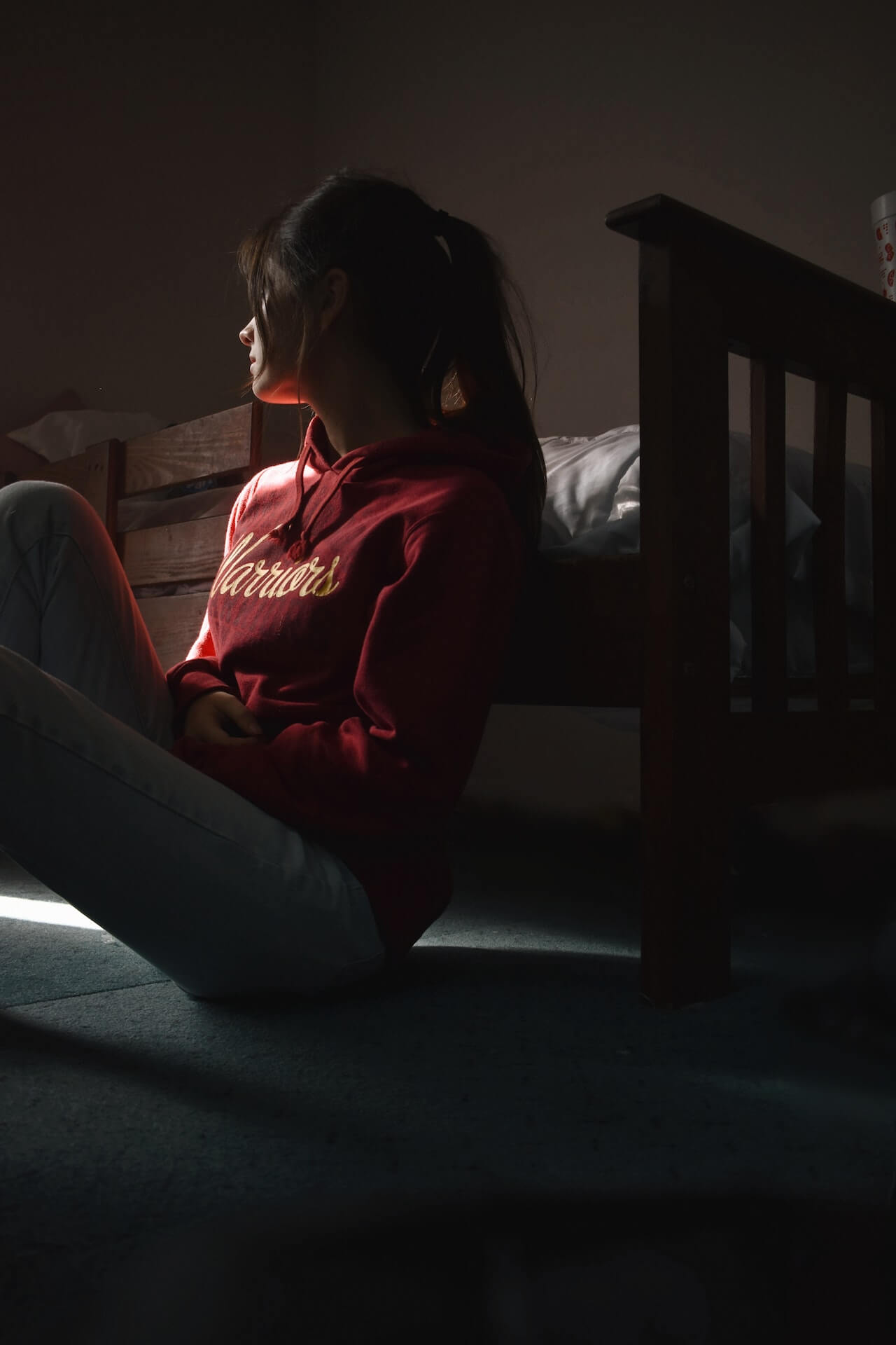 lonely-and-sad-woman-sitting-on-the-floor-at-sunrise