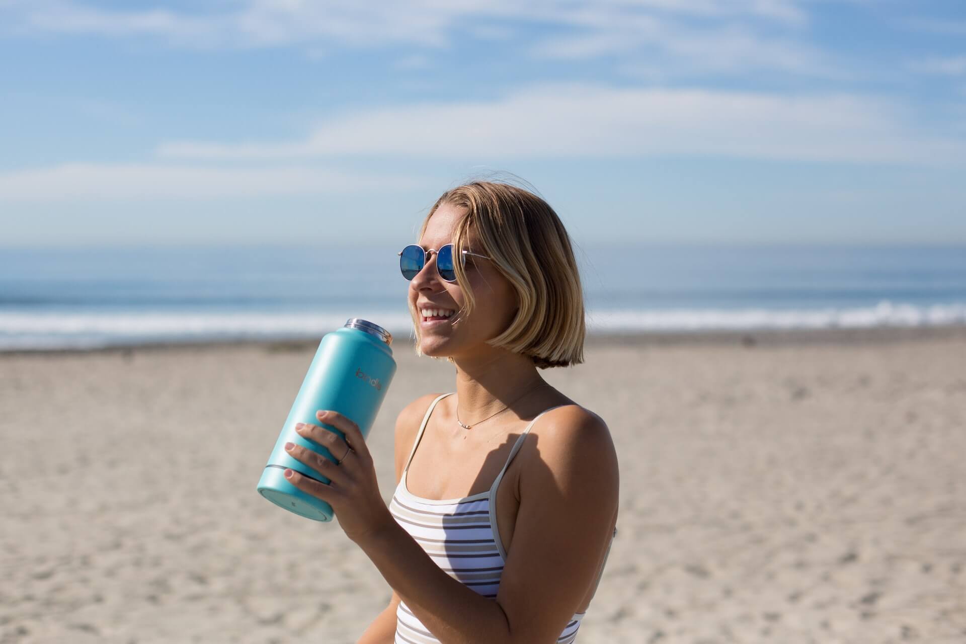 Woman-holding-big-water-bottle-otuside-sleepy-after-workout