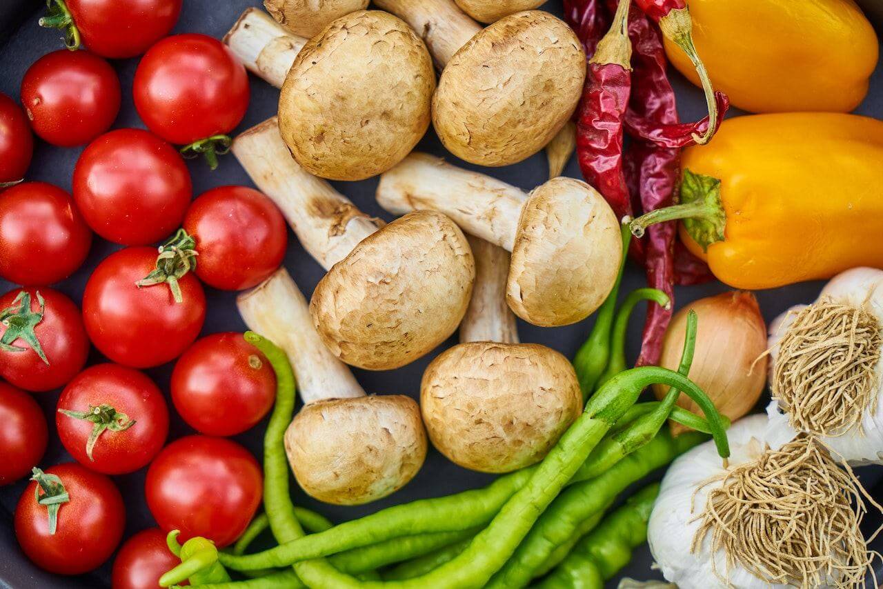 Fresh-vegetables-laying-on-top-of-black-counter