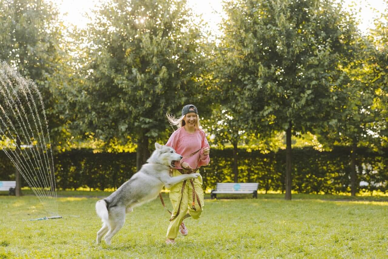 Woman-playing-with-her-dog-outside