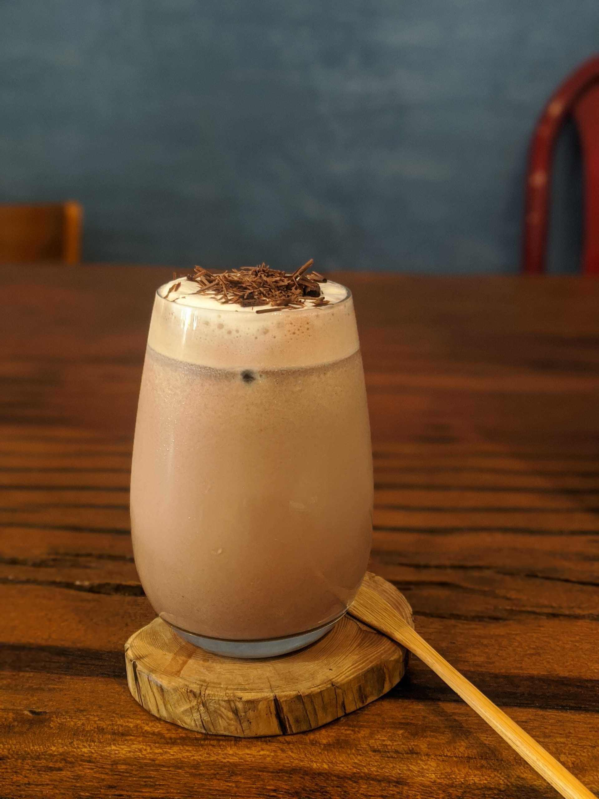 Glass-of-chocolate-milk-with-chocolate-sprinkled-on-top