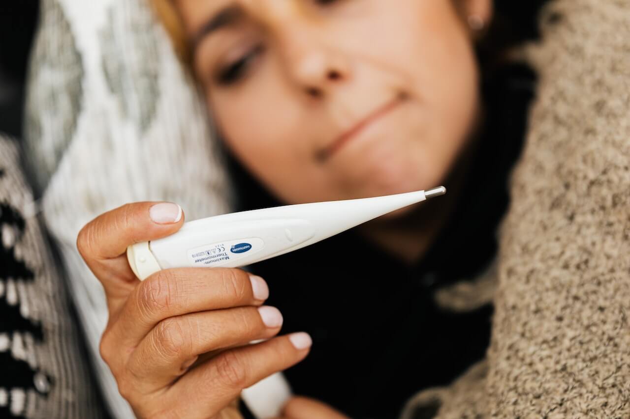 woman-using-thermometer-for-fever