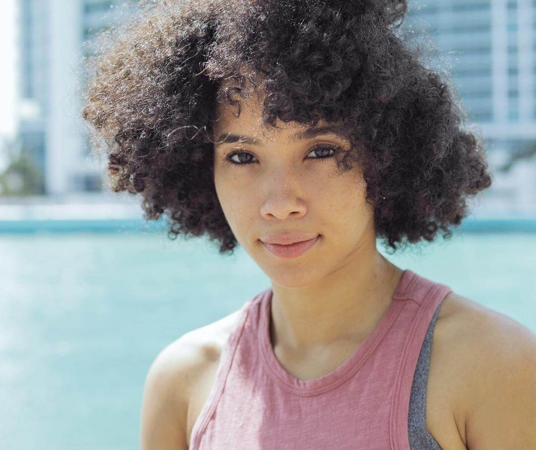 Woman smiling at camera with cityscape in the background