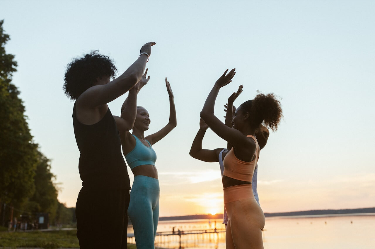 Happy-group-of-people-after-workout-giving-high-five