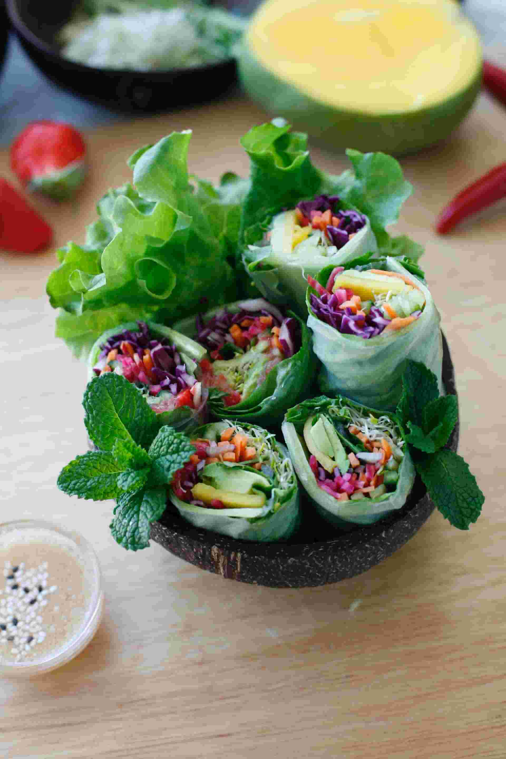 Coconut-bowl-full-of-fresh-vietnamese-rolls-and-leaves