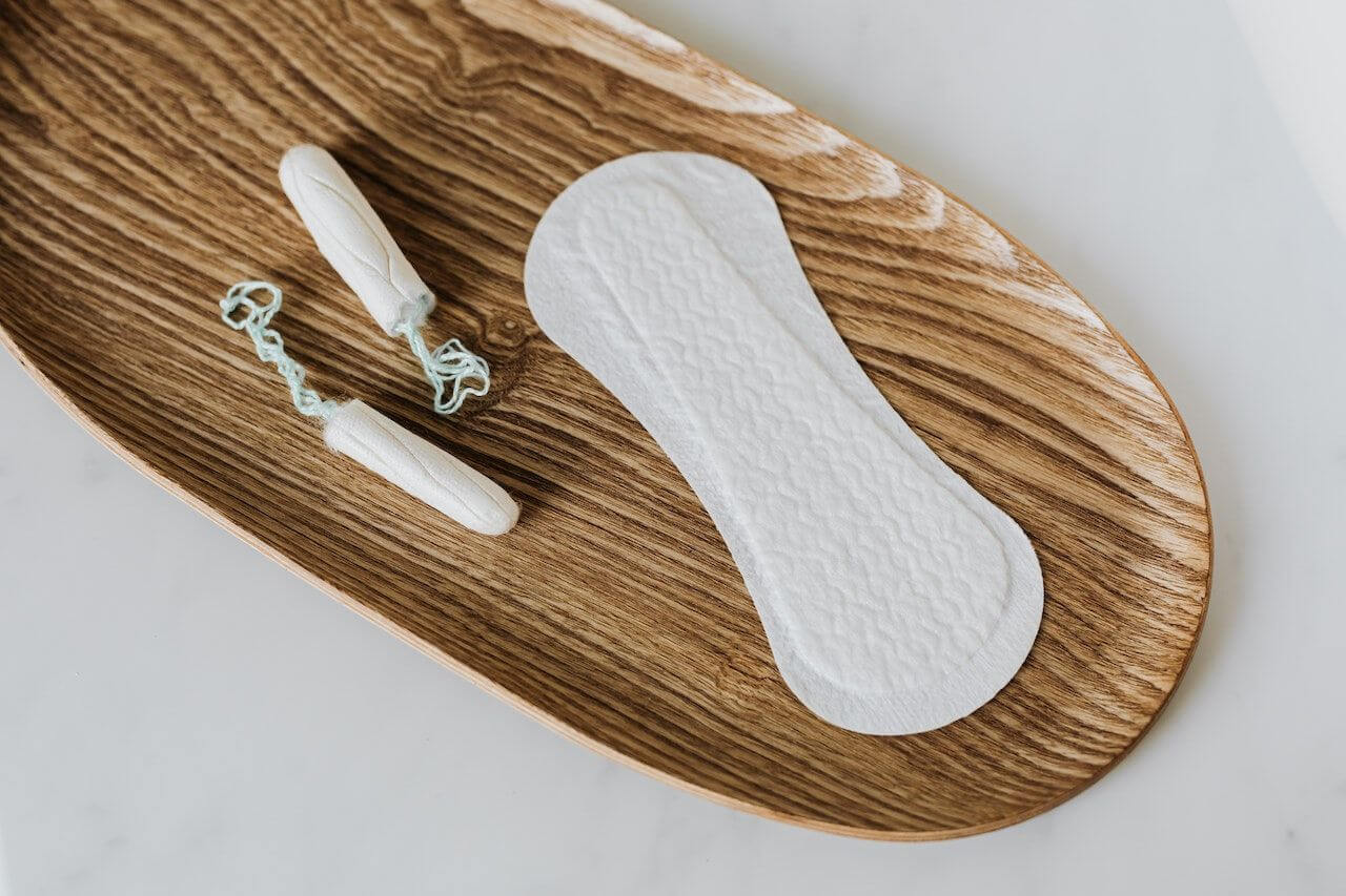 pad-and-tampons-on-wooden-table