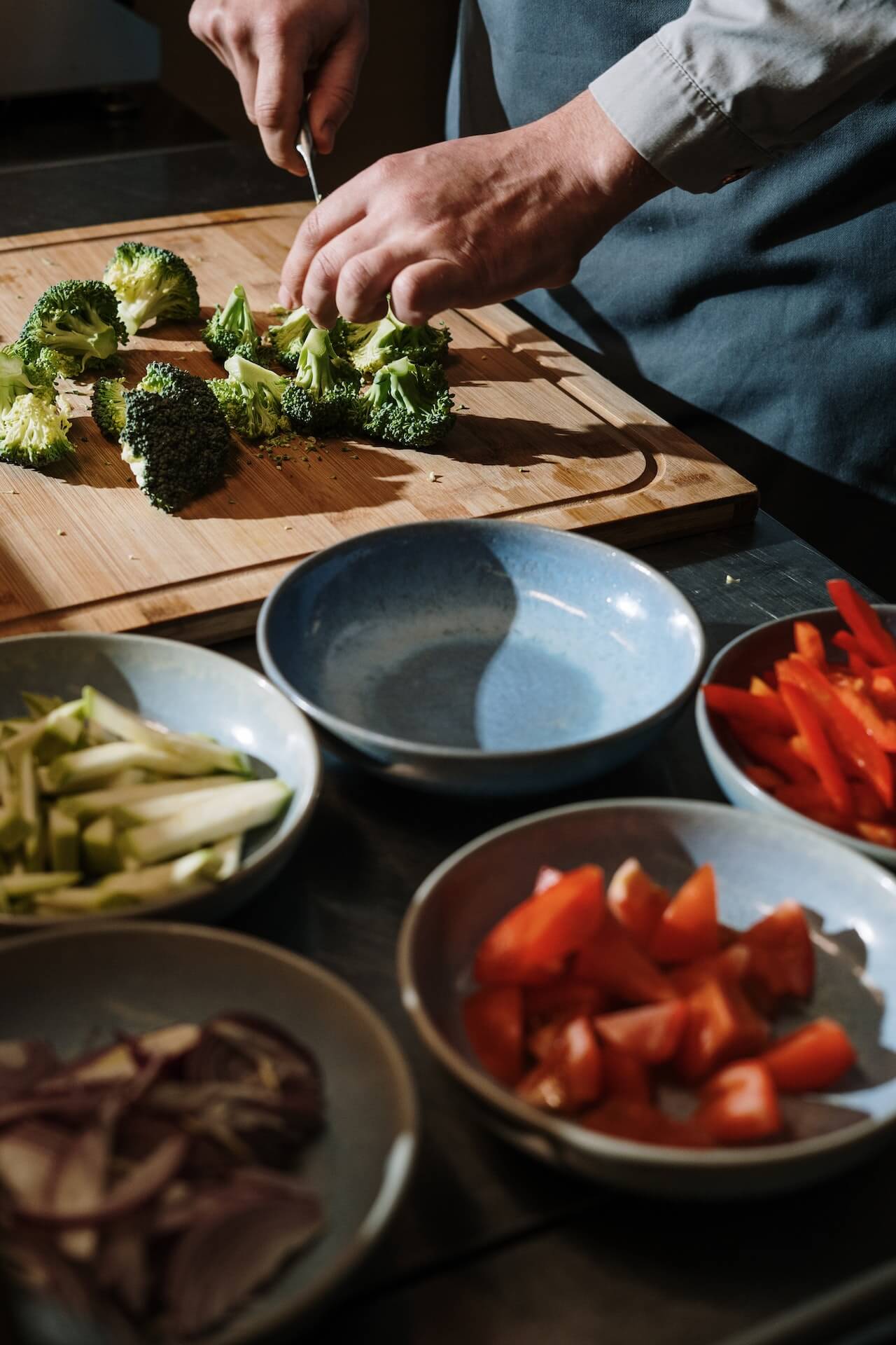 man-cooking-vegetables-in-house