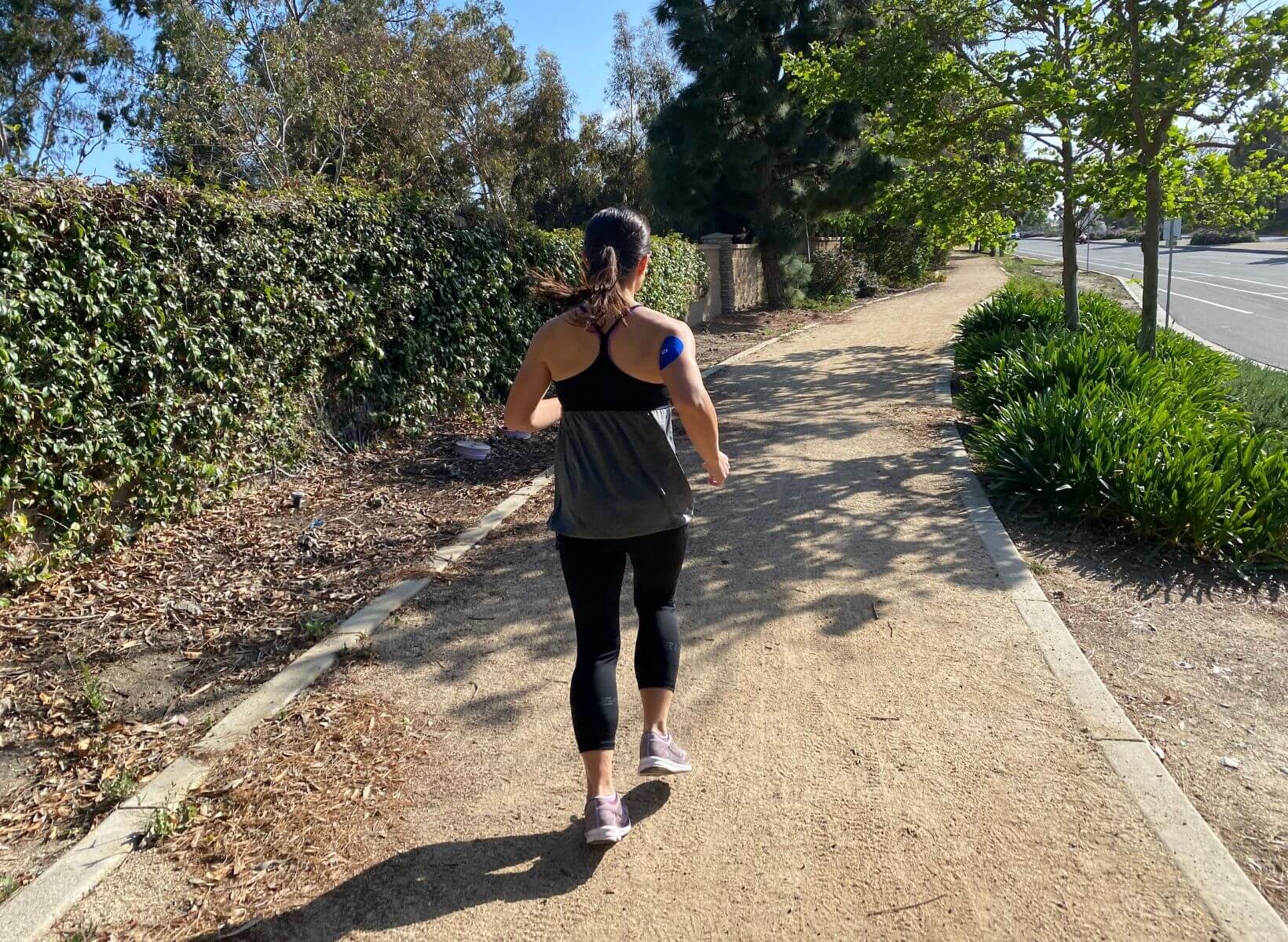 woman running with a CGM to mitigate a glucose spike