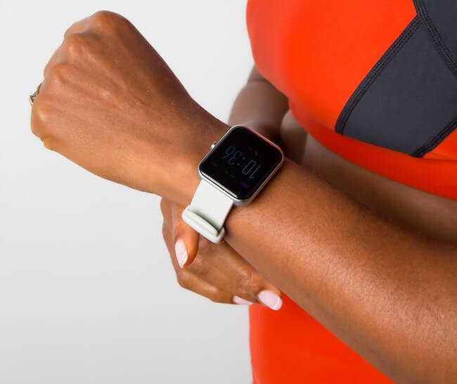 Woman wearing workout clothes and wearing apple watch