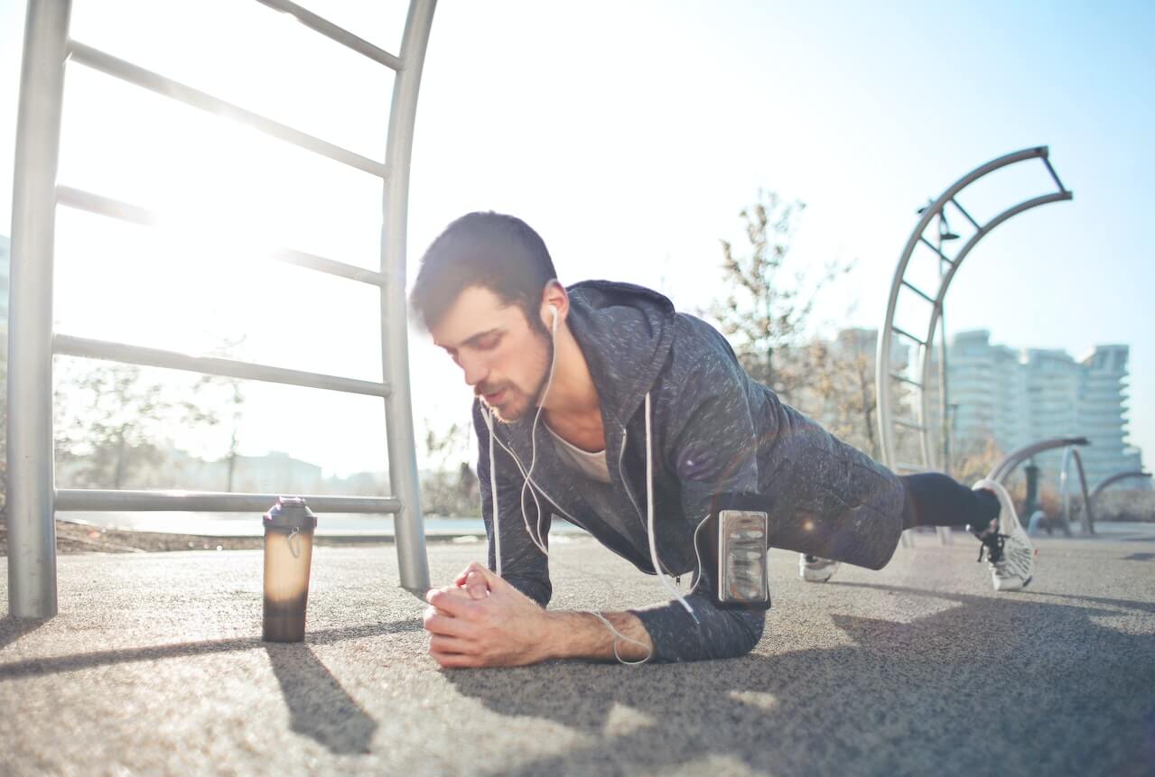 man-doing-planks-at-park-in-the-morning