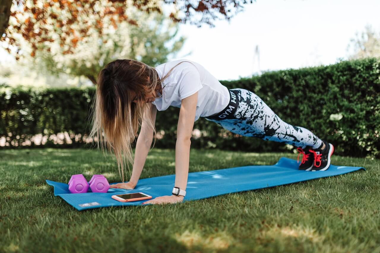 Woman in activewear doing push-ups