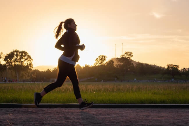 Woman running at dawn