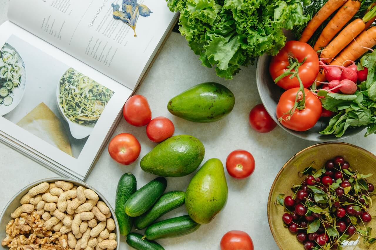 Vegetables over a table next to a book