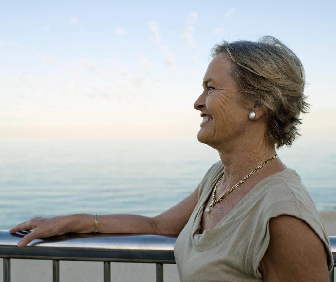 woman smiling looking at the ocean