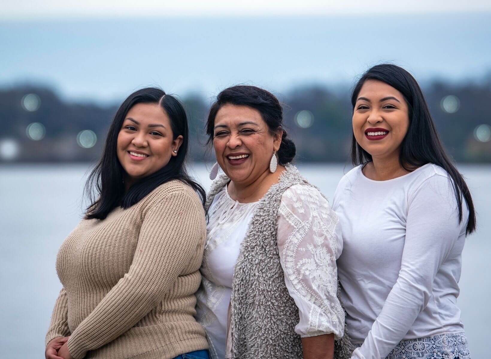 Three Hispanic woman standing close to one another. Each woman is a bit overweight, and might want to lose weight