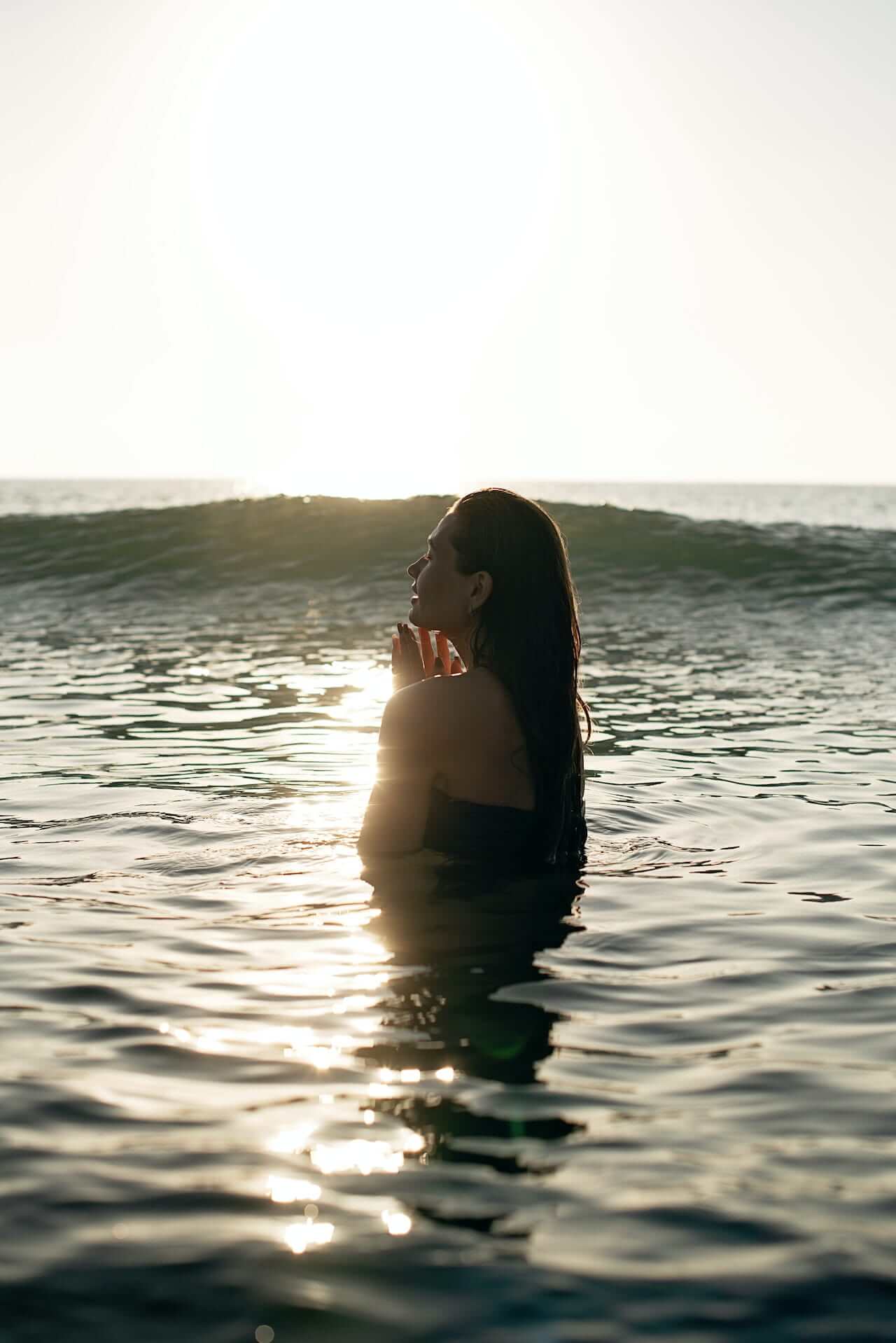 woman-swimming-in-rippling-sea-at-sundown