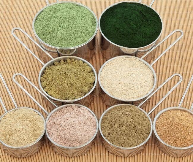 Various powdered supplements displayed on a tabletop